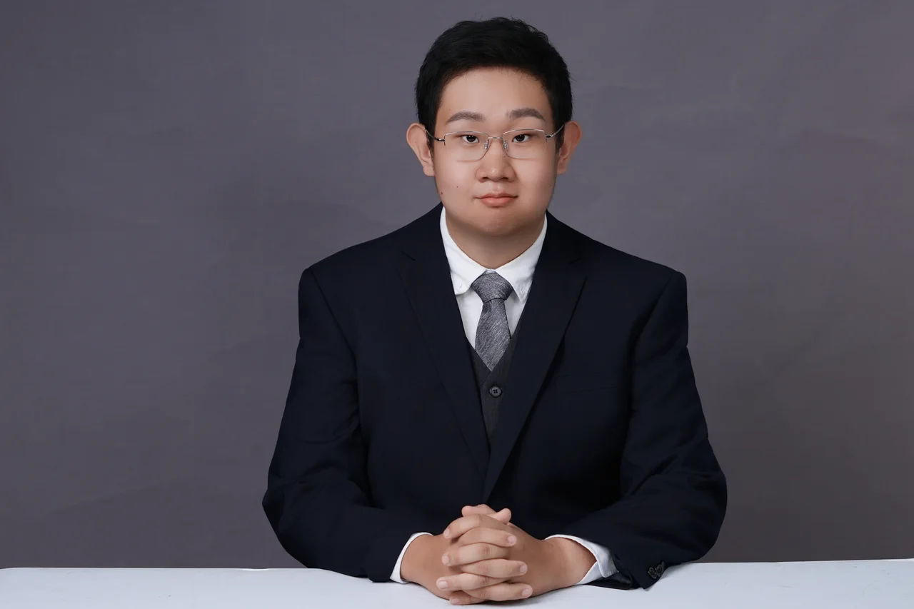 David seated in a suit